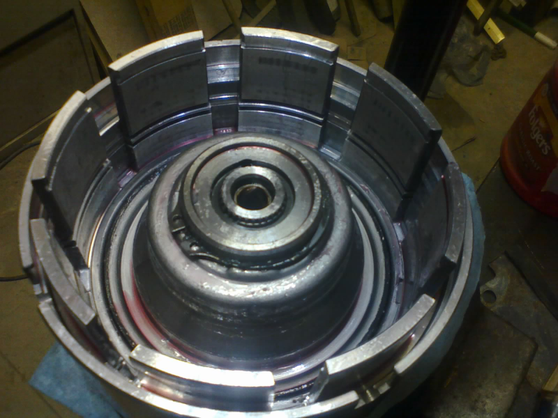With the pistons finally aligned and seated, this snap-ring holds the big return spring down, and we can release the compressor